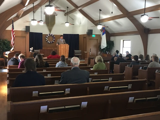 The congregation listening to a speaker at the pulpit in Anchor's timber-beamed sanctuary.